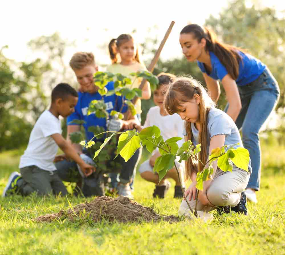 Children and adult volunteers planting trees under Group 36 fiscal sponsorship and 501(c)(3) tax-exempt oversight